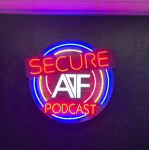 This is an image of a round neon sign for Podcasts on a black wall.