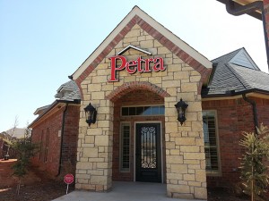 Another photo of wall sign for Petra Roofing.