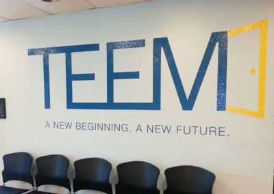 Picture of large vinyl graphic on wall for that says TEEM.