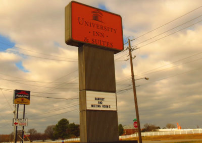 Daytime picture of University Inn pylon sign.