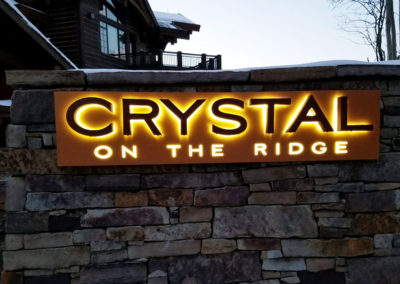Picture of a halo illuminated channel letters that say Crystal.